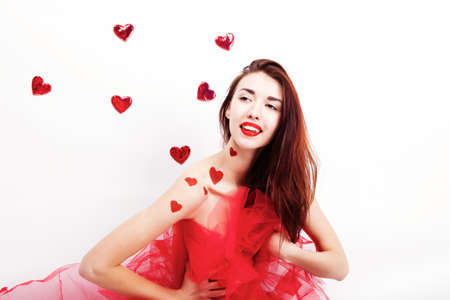 Brunette girl with red hearts isolated on whiteの写真素材