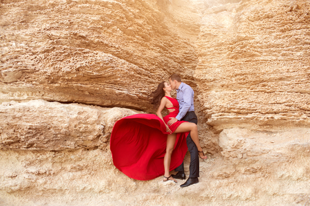 Beautiful couple portrait dancing near the rocksの写真素材