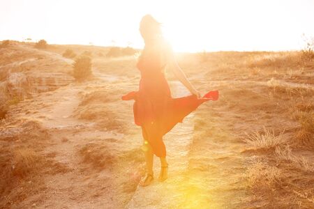 Young woman outdoor portrait in red dressの写真素材