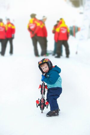 toddler boy skiing in the mountains, winter timeの写真素材
