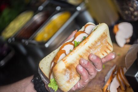 Close up photo of hands holding  big tasty sandwichの写真素材