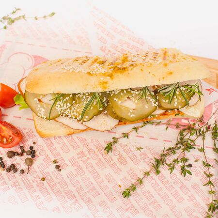 Long Ciabatta Sandwich with lettuce, slices of fresh tomatoes, cucumberの写真素材