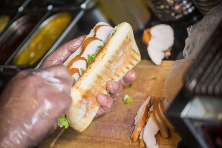 Close up photo of hands holding  big tasty sandwichの写真素材