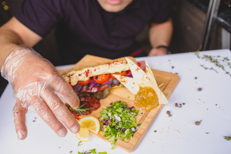 Close up photo of hands holding  big tasty sandwichの写真素材