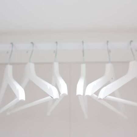 composition with white wooden hangers in the closetの写真素材