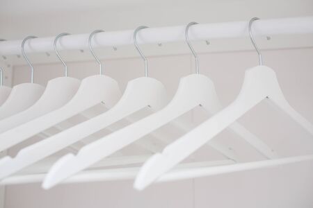 composition with white wooden hangers in the closetの写真素材