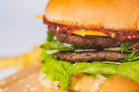 fresh tasty burger and french fries isolated on whiteの写真素材