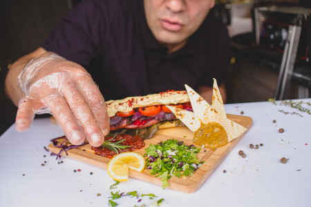 Close up photo of hands holding  big tasty sandwichの写真素材