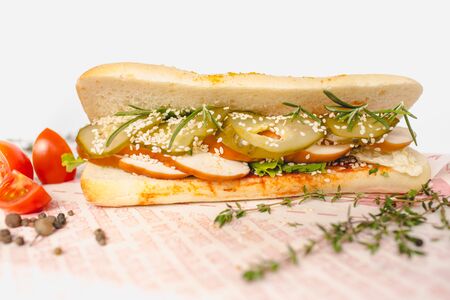 Long Ciabatta Sandwich with lettuce, slices of fresh tomatoes, cucumberの写真素材