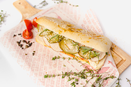 Long Ciabatta Sandwich with lettuce, slices of fresh tomatoes, cucumberの写真素材
