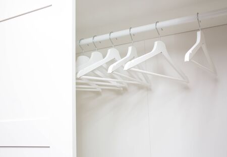 composition with white wooden hangers in the closetの写真素材
