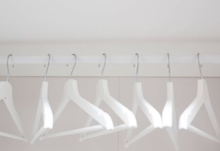 composition with white wooden hangers in the closetの写真素材