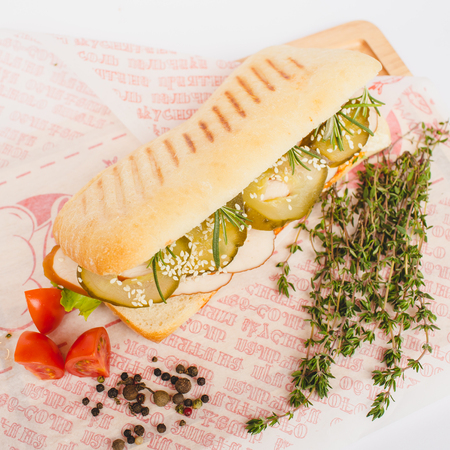 Long Ciabatta Sandwich with lettuce, slices of fresh tomatoes, cucumberの写真素材