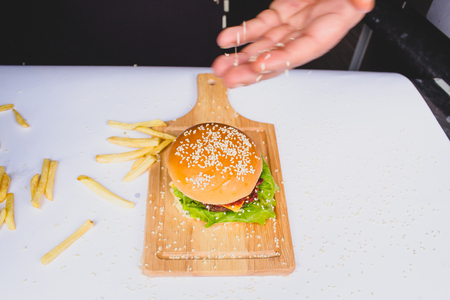 fresh tasty burger and french fries isolated on whiteの写真素材