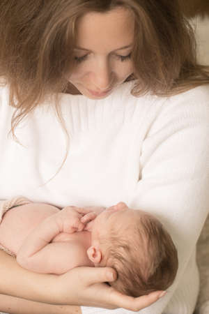 Cute infant on the hands of motherの写真素材