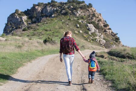 Beautiful family of mother and son walking near the seaの写真素材