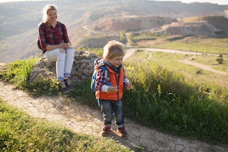 Beautiful family of mother and son walking near the seaの写真素材