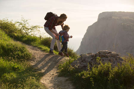 Beautiful family of mother and son walking near the seaの写真素材