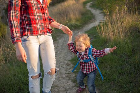 Beautiful family of mother and son walking near the sea