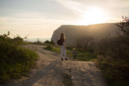 Beautiful family of mother and son walking near the seaの写真素材