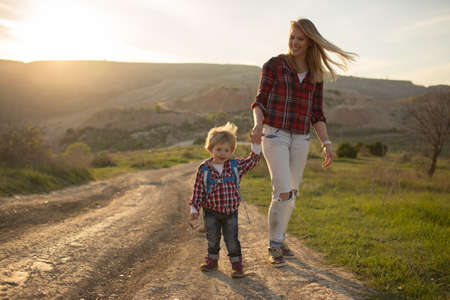 Beautiful family of mother and son walking near the seaの写真素材