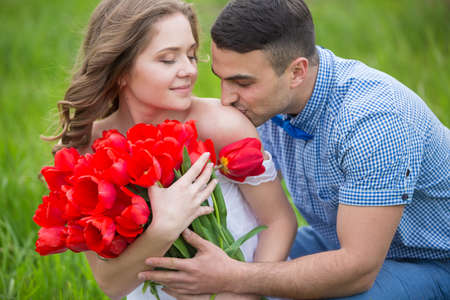 Young couple in love on the flower meadowの写真素材