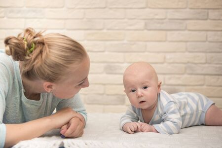 Portrait of happy young mother and baby at homeの写真素材