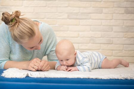 Portrait of happy young mother and baby at homeの写真素材