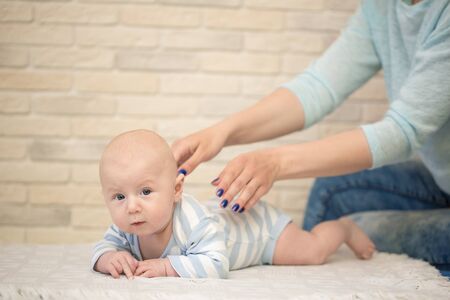 Portrait of happy young mother and baby at homeの写真素材
