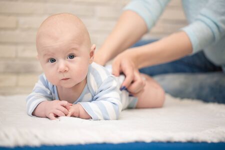 Portrait of happy young mother and baby at homeの写真素材