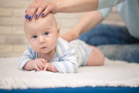 Portrait of happy young mother and baby at homeの写真素材