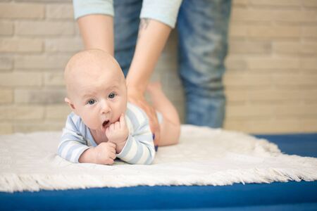 Portrait of happy young mother and baby at homeの写真素材