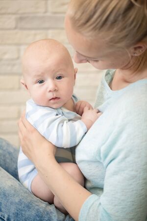 Portrait of happy young mother and baby at homeの写真素材