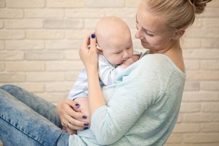 Portrait of happy young mother and baby at homeの写真素材