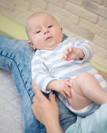 Portrait of happy young mother and baby at homeの写真素材