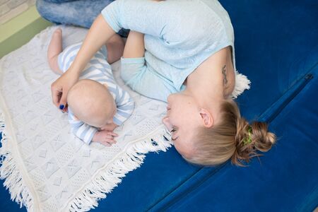 Portrait of happy young mother and baby at homeの写真素材