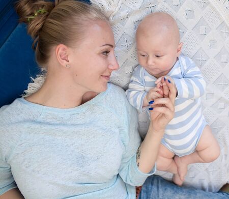 Portrait of happy young mother and baby at homeの写真素材
