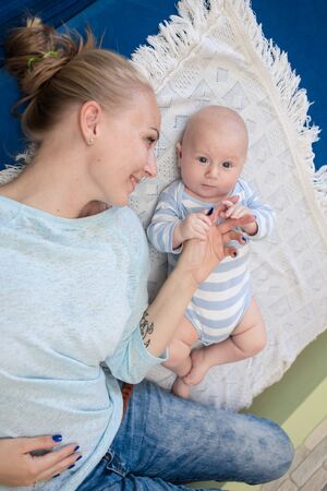 Portrait of happy young mother and baby at homeの写真素材