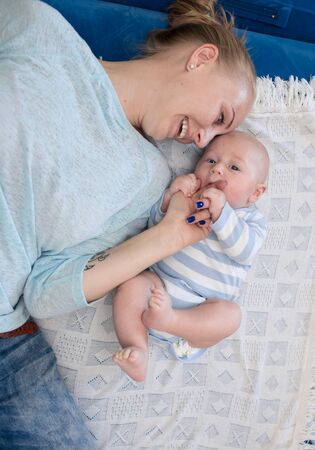 Portrait of happy young mother and baby at homeの写真素材