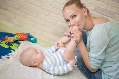 Portrait of happy young mother and baby at homeの写真素材