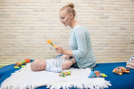 Portrait of happy young mother and baby at homeの写真素材