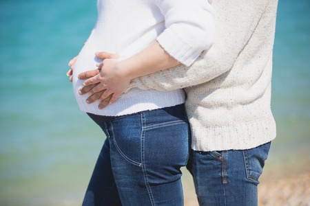 Happy family of two person walking on the beachの写真素材