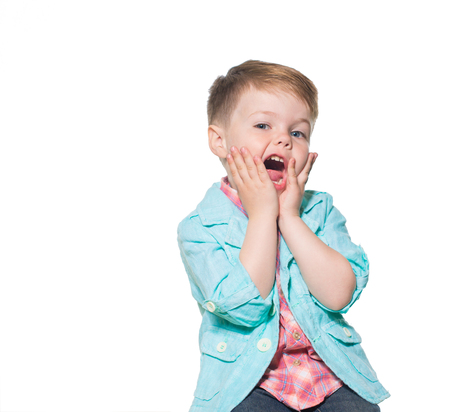 Cheerful little boy play the ape in studio. Isolated on white background.の写真素材