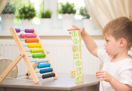 Little boy playing with abacus toy at homeの写真素材