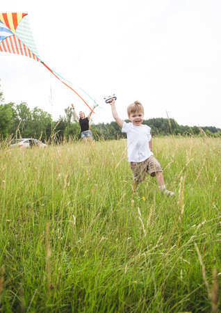 Father and son relationship, playing with kite in the parkの写真素材