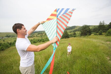 Father and son relationship, playing with kite in the parkの写真素材