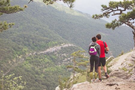 Couple of hikers looking from mountains in Crimea.の写真素材