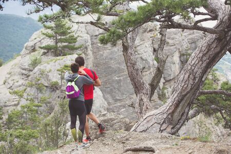 Couple of hikers looking from mountains in Crimea.の写真素材