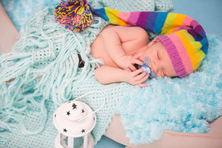 Studio portrait of newborn baby boy sleeping in bed.の写真素材