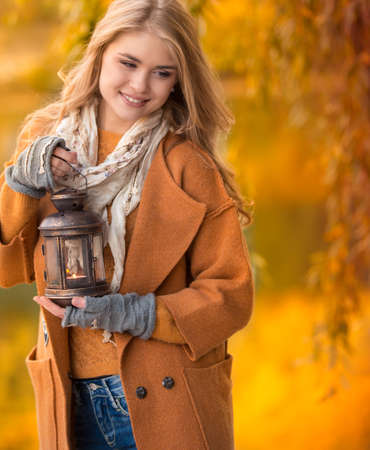 Young woman on the yellow maple garden backgroundの写真素材